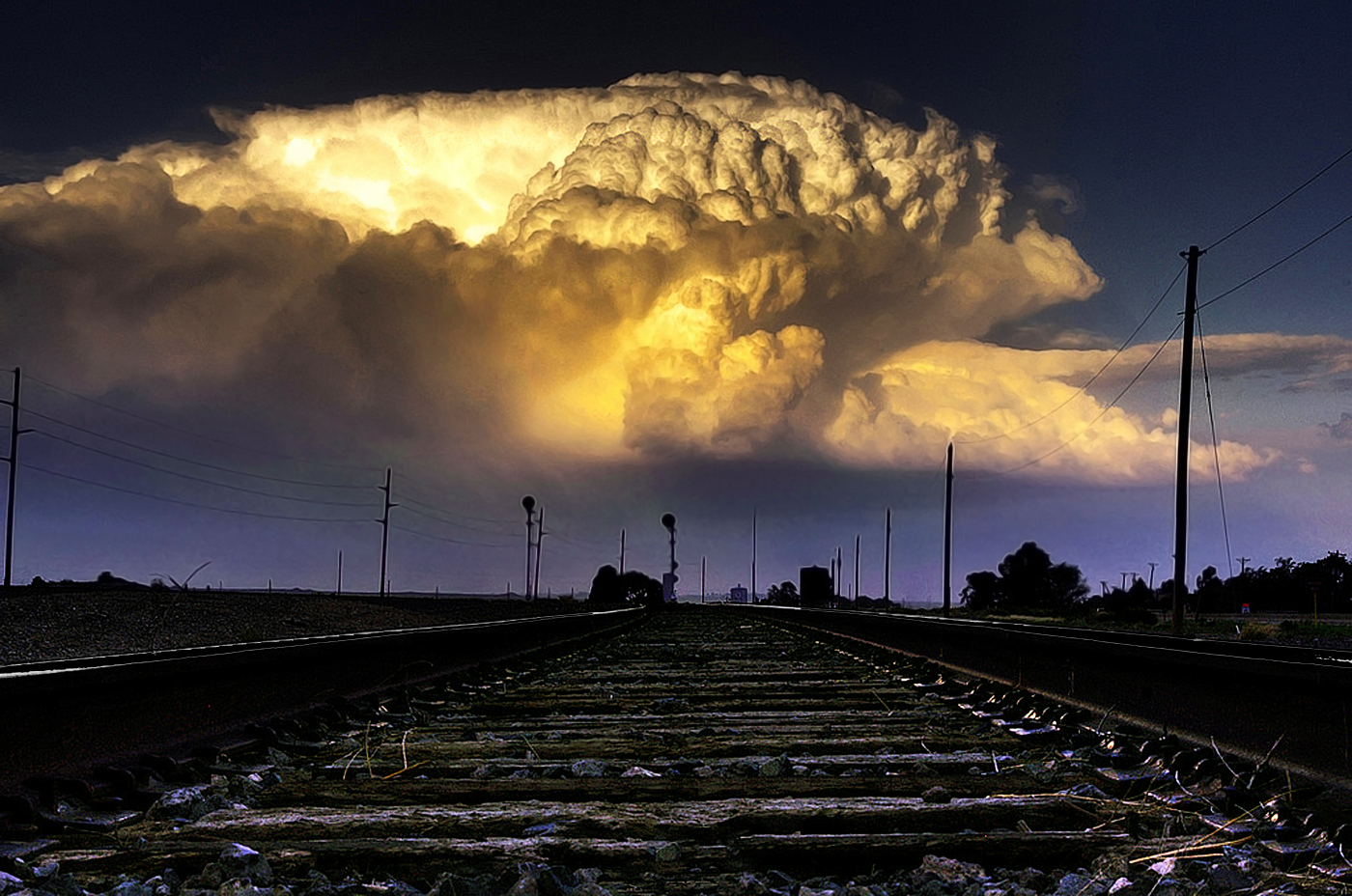 An oldie but one of my favorites. You may have picked up on my technique of using roads and railroad tracks to draw the viewer into the storm. It works well if you can line it up right. Pueblo Colorado Severe Thunderstorm.