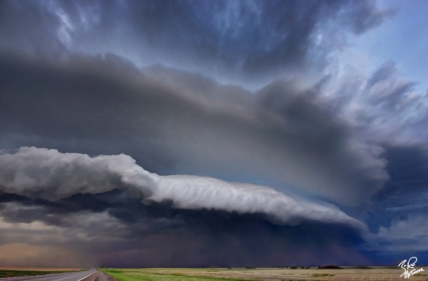 After witnessing an amazing low precipitation supercell near Ashland Kansas this past May, I began to make my way back to Colorado and ran into an unexpected photo session. A huge picturesque shelf cloud with intense straight line winds was over turning semi trailers just SE of Dodge City, Kansas.