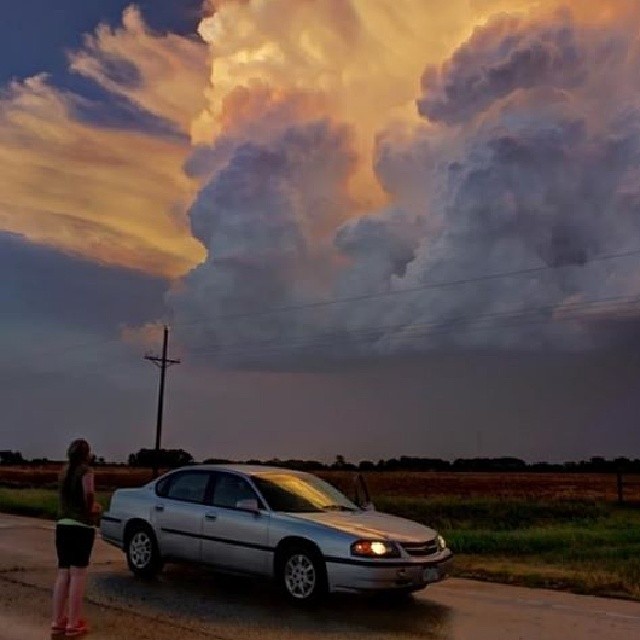 My chase partner @edaaaaj admiring a sunlit updraft in W #Kansas in 2012. #beautiful #photography #pics