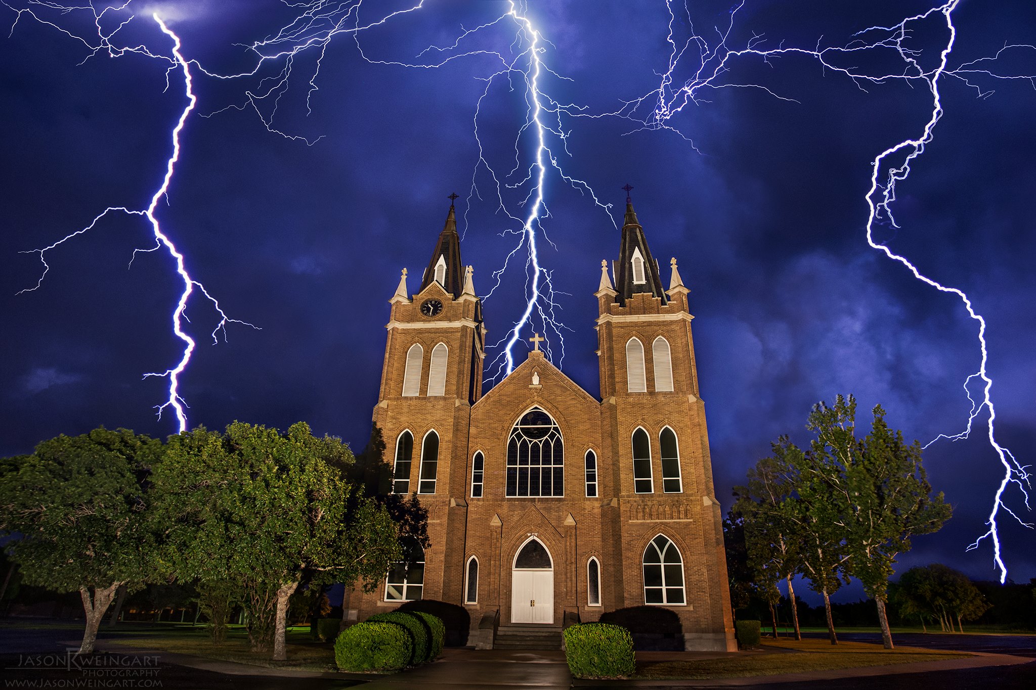 Lightning strikes behind the Holy Trinity Catholic Church in Schwertner, Texas - 07.17.14 6 stacked images Church f/7.1 13 seconds ISO 1600 Lightning f/7.1 13 seconds ISO 200.